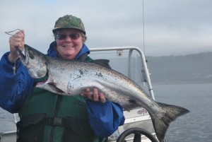 Roy Morris' wife, Nancy Messmer, holds up a chinook salmon she caught off the coast of Sekiu, Washington. (Courtesy of Nancy Messmer)